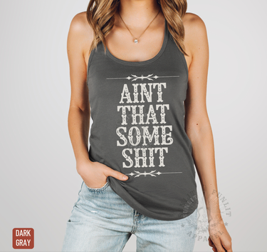 A woman wearing a gray tank top with the text